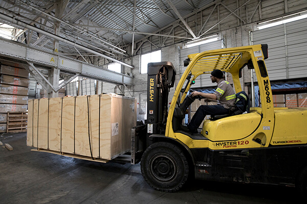 forklift transporting cargo inside a warehouse